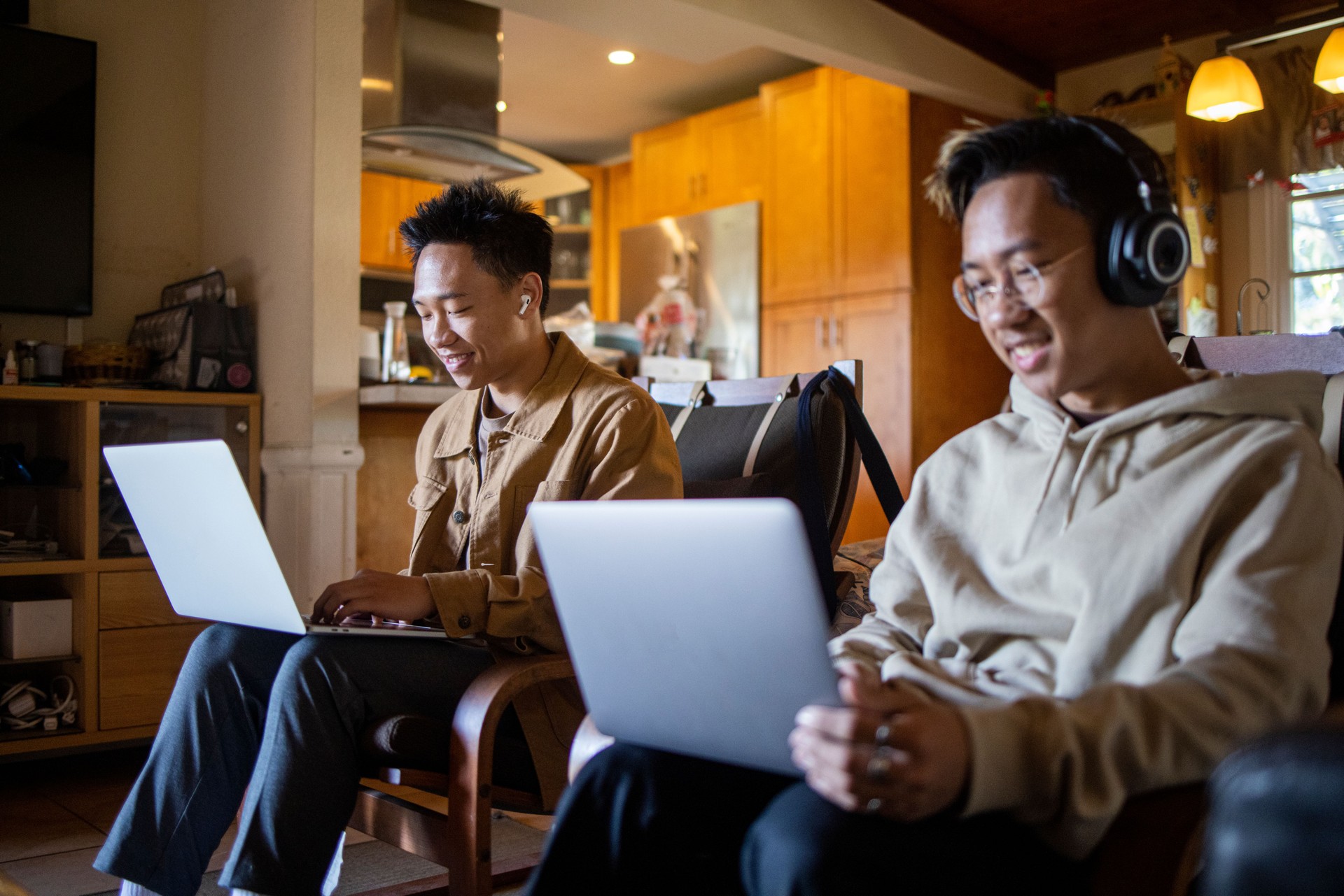 Two Filipino Brothers On Laptops in Livingroom