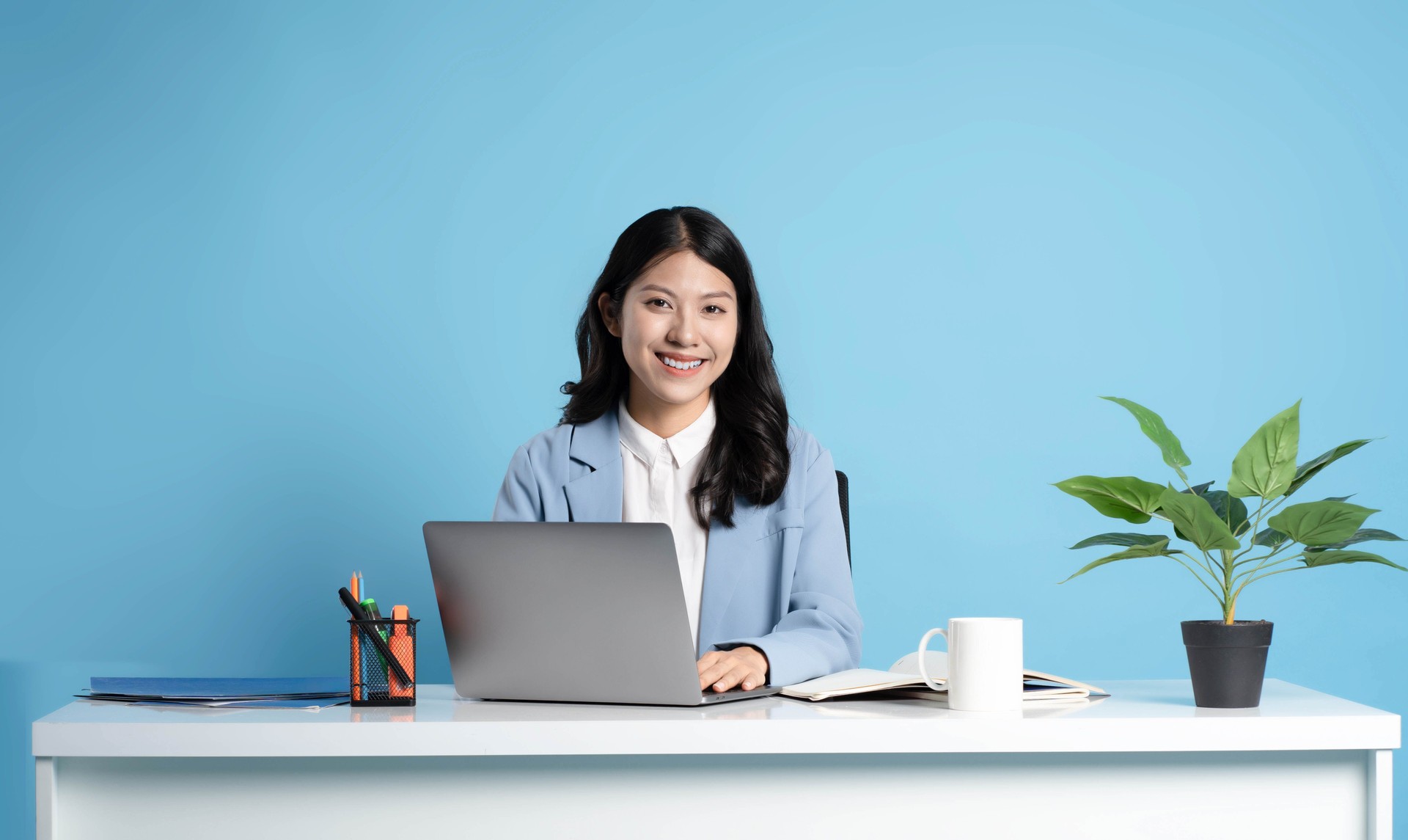 image of asian businesswoman sitting and using laptop on desk